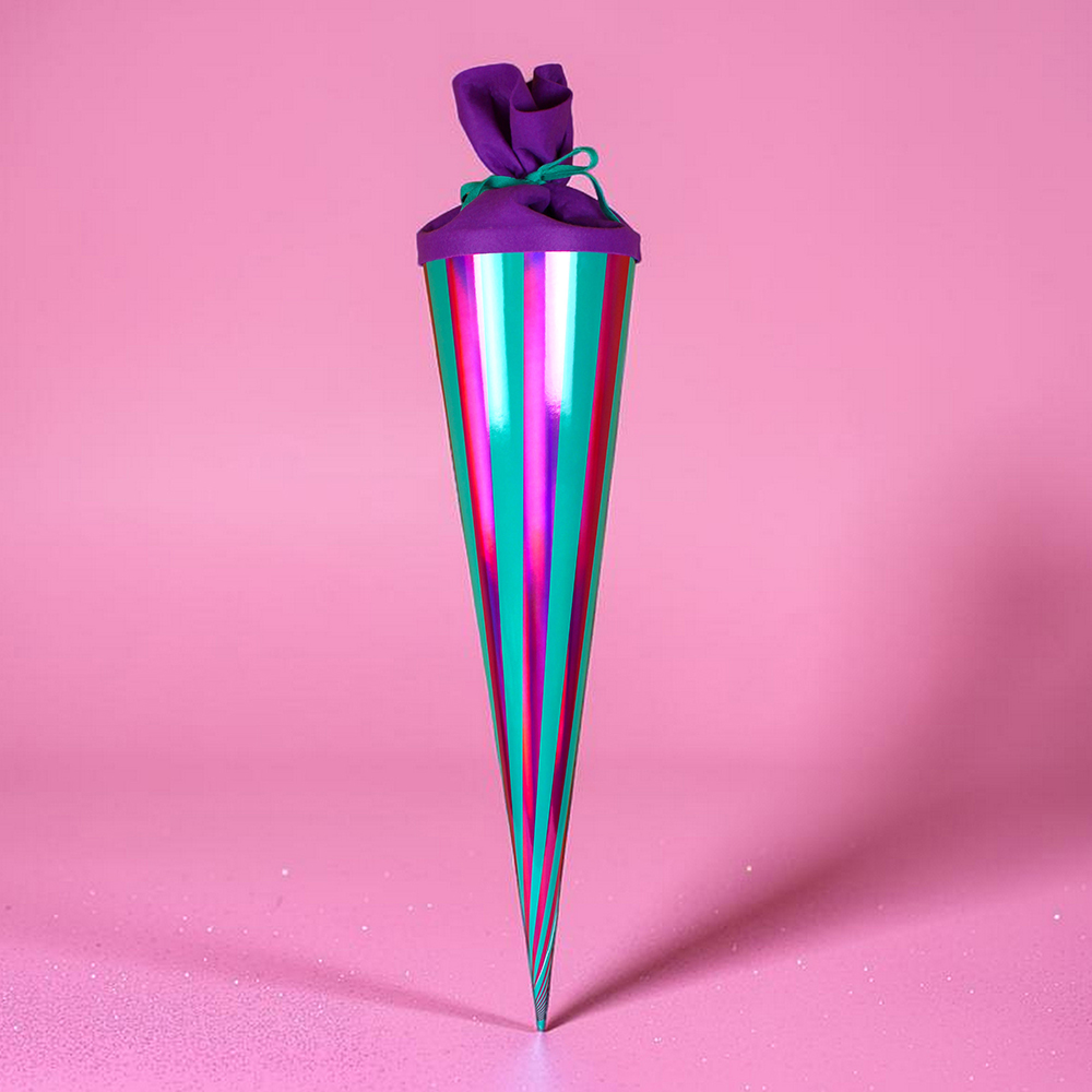 Vertical, multi-colored striped party cone with a purple fabric knot at the top on a pink background.