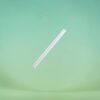 White plastic straw angled diagonally across a mint-green background.