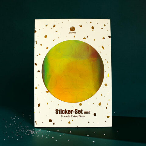 Box of 'Sticker-Set rund' packaging with a large holographic circle and gold confetti on white background; product name visible at bottom.