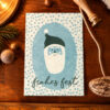 Blue holiday card featuring a simple Santa face and 'frohes fest' text on a dotted background.