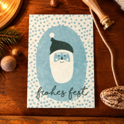 Blue holiday card featuring a simple Santa face and 'frohes fest' text on a dotted background.