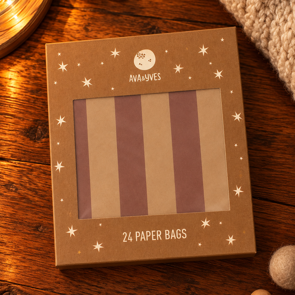 Brown starry packaging for Ava & Yves 24 paper bags on a wooden table, warm lighting.
