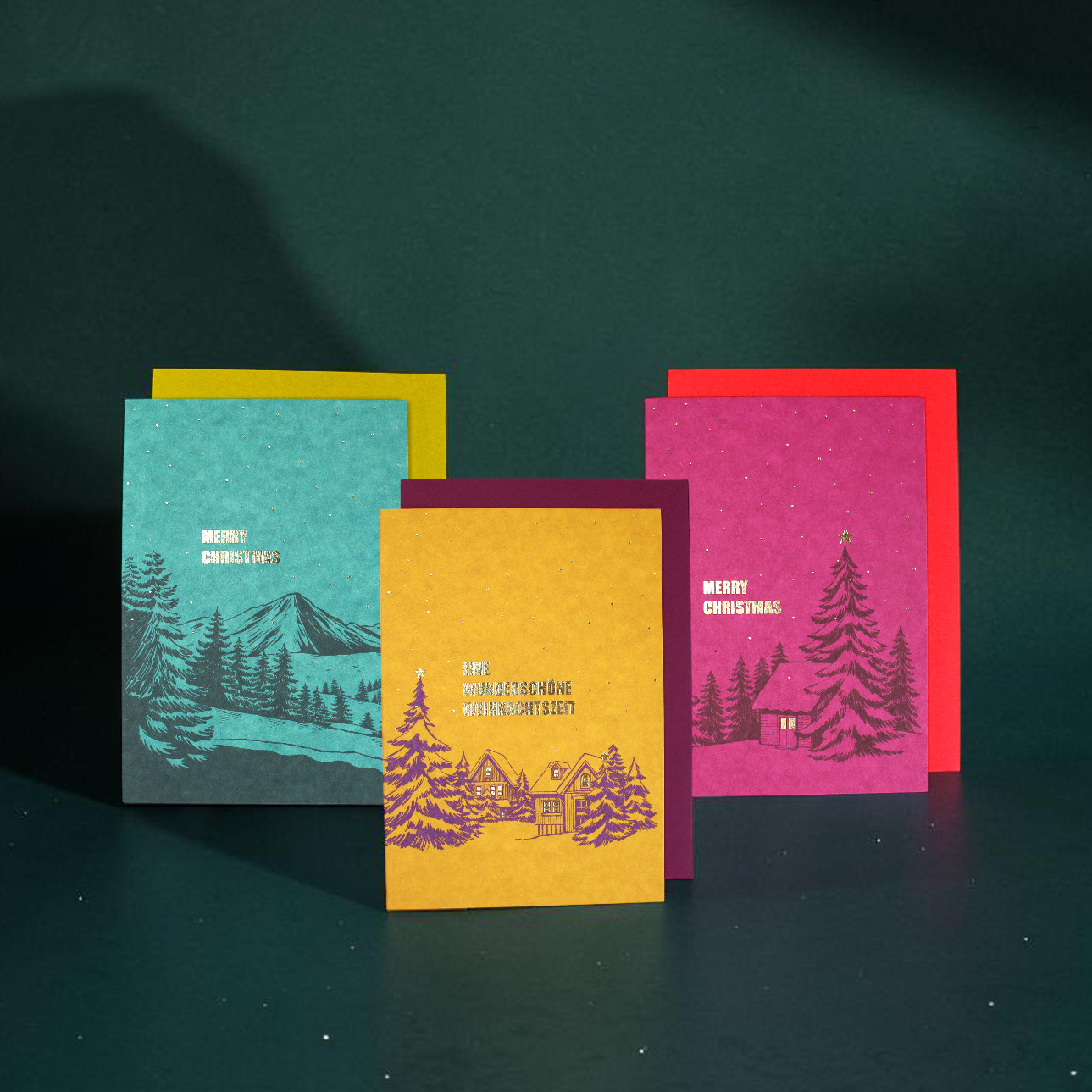 Set of four colorful Christmas cards with winter village illustrations and 'Merry Christmas' text on teal, yellow, purple, and pink cards.
